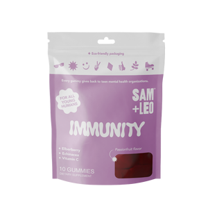 A stand-up pouch package of SAM + LEO Immunity gummies, featuring a lavender purple design with white text and a small window showing the dark red gummies inside, set against a plain white background.